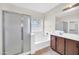 Bright bathroom with glass-enclosed shower, soaking tub, and double sink vanity at 17008 W Sonora St, Goodyear, AZ 85338