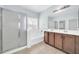 Bathroom with double vanity, tub, separate shower, and tile flooring at 17008 W Sonora St, Goodyear, AZ 85338