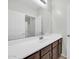 Bright bathroom features a large mirror and modern single sink vanity at 17008 W Sonora St, Goodyear, AZ 85338