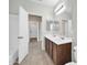 Bright bathroom with tiled floors and double sink vanity at 17008 W Sonora St, Goodyear, AZ 85338