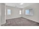 Spacious bedroom featuring neutral carpeting, ample natural light, and a large window at 17008 W Sonora St, Goodyear, AZ 85338