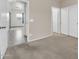View of a carpeted bedroom with a closet and doorway into another room with grey tiled flooring at 17008 W Sonora St, Goodyear, AZ 85338