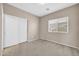 Cozy bedroom featuring neutral paint, carpet flooring, a window, and a closet with sliding doors at 17008 W Sonora St, Goodyear, AZ 85338
