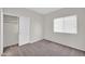 Clean bedroom offers neutral carpeting, closet and bright window at 17008 W Sonora St, Goodyear, AZ 85338