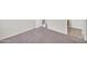 Bright bedroom with neutral carpet and walls with entry to tiled space at 17008 W Sonora St, Goodyear, AZ 85338