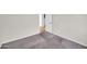 Bedroom with neutral walls, plush gray carpeting, and an open doorway into another room at 17008 W Sonora St, Goodyear, AZ 85338