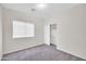 Cozy bedroom with a window, closet, neutral walls, and soft carpeting at 17008 W Sonora St, Goodyear, AZ 85338