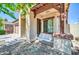 Inviting covered porch showcasing a swing seat and beautiful beams at 17008 W Sonora St, Goodyear, AZ 85338