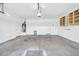 Spacious garage with painted concrete flooring and attached cabinetry, a hot water tank and lighting at 17008 W Sonora St, Goodyear, AZ 85338