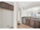 Kitchen featuring wood cabinets, stainless appliances, tile floors and a breakfast bar at 17008 W Sonora St, Goodyear, AZ 85338