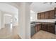 Open concept with kitchen, stainless steel appliances, and tile floors at 17008 W Sonora St, Goodyear, AZ 85338