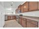 Kitchen area with stainless steel appliances, tile floors, and wood cabinets at 17008 W Sonora St, Goodyear, AZ 85338