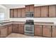 Well-equipped kitchen features wood cabinets, stainless steel appliances, and ample counter space at 17008 W Sonora St, Goodyear, AZ 85338