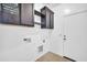 Functional laundry room with storage cabinets and utility connections for appliances at 17008 W Sonora St, Goodyear, AZ 85338