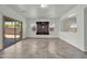Bright living room with sliding glass doors and a stylish built-in entertainment center at 17008 W Sonora St, Goodyear, AZ 85338