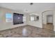 Spacious living room with tile flooring, media center, and great natural light from large windows at 17008 W Sonora St, Goodyear, AZ 85338