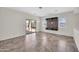Bright living room with tile floors, a media center, and sliding glass door to the backyard at 17008 W Sonora St, Goodyear, AZ 85338