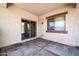 Covered patio off the main house, featuring a large window and a sliding glass door entrance to the house at 17008 W Sonora St, Goodyear, AZ 85338
