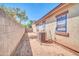 Side yard featuring block wall fencing and a functional AC unit, enclosed for added privacy and security at 17008 W Sonora St, Goodyear, AZ 85338
