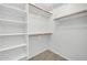 A walk-in closet with built-in shelving and wooden rods at 17008 W Sonora St, Goodyear, AZ 85338