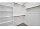 Spacious walk-in closet with built-in shelves and rods for optimal organization at 17008 W Sonora St, Goodyear, AZ 85338