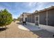 The backyard featuring desert landscaping, a grill, and a covered patio, perfect for outdoor enjoyment at 18137 N Plaza Ct, Surprise, AZ 85374