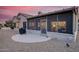 The backyard featuring desert landscaping, a grill, and a covered patio, perfect for outdoor enjoyment at 18137 N Plaza Ct, Surprise, AZ 85374