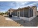 The backyard featuring desert landscaping, a grill, and a covered patio, perfect for outdoor enjoyment at 18137 N Plaza Ct, Surprise, AZ 85374