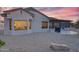 This beautiful backyard features a screened in patio, desert landscaping, and a built-in BBQ at 18137 N Plaza Ct, Surprise, AZ 85374