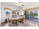 Dining area with wood flooring, a ceiling fan, and access to the patio at 18137 N Plaza Ct, Surprise, AZ 85374