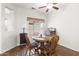Cozy dining area with wood flooring, a ceiling fan, and a round wood table at 18137 N Plaza Ct, Surprise, AZ 85374