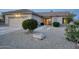 Charming home features desert landscaping, a front-facing garage, and a well-maintained facade at 18137 N Plaza Ct, Surprise, AZ 85374