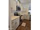 Bright kitchen features stainless steel appliances, light countertops, and painted cabinets at 18137 N Plaza Ct, Surprise, AZ 85374