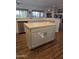 Neutral kitchen island featuring a light countertop and light gray cabinets at 18137 N Plaza Ct, Surprise, AZ 85374