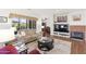 Spacious living area with fireplace, built-in media center, and views of the backyard at 18137 N Plaza Ct, Surprise, AZ 85374