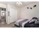 Bedroom featuring carpet, modern decor, sliding closet, and a ceiling fan at 18850 N 16Th Pl, Phoenix, AZ 85024
