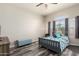 Bedroom featuring wood-look flooring, neutral walls, window, and a ceiling fan at 18850 N 16Th Pl, Phoenix, AZ 85024