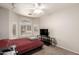 Bedroom featuring a window, carpet, ceiling fan, and dark red bedspread at 18850 N 16Th Pl, Phoenix, AZ 85024