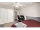 Neutral bedroom with carpet, closet, a fan, and black desk at 18850 N 16Th Pl, Phoenix, AZ 85024