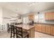 Bright eat-in kitchen featuring a kitchen island, light wood cabinets and stainless steel appliances at 18850 N 16Th Pl, Phoenix, AZ 85024