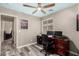 Comfortable office space with a ceiling fan, dual monitors on a wood desk, and modern wood-look flooring at 18850 N 16Th Pl, Phoenix, AZ 85024