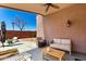 Relaxing covered patio with comfortable seating and a ceiling fan, perfect for outdoor enjoyment at 18850 N 16Th Pl, Phoenix, AZ 85024