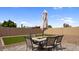 Cozy backyard featuring a patio with outdoor dining set and a well-maintained artificial grass area at 1924 S 82Nd Cir, Mesa, AZ 85209