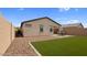 Beautiful backyard featuring desert landscaping, artificial grass, and a cozy patio area at 1924 S 82Nd Cir, Mesa, AZ 85209