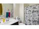 Bathroom with white countertop sink, black vanity and gaming-themed shower curtain at 1924 S 82Nd Cir, Mesa, AZ 85209