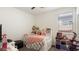 Bright bedroom featuring a full sized bed with a white frame and a window at 1924 S 82Nd Cir, Mesa, AZ 85209