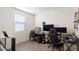 Bedroom featuring wood-look floors, natural light from the window, and gaming setup at 1924 S 82Nd Cir, Mesa, AZ 85209