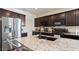 Stylish kitchen equipped with stainless steel appliances, dark cabinets, and a large island with a sink at 1924 S 82Nd Cir, Mesa, AZ 85209