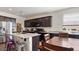 Bright kitchen with dark wood cabinets, granite countertops, and stainless steel appliances, and large island at 1924 S 82Nd Cir, Mesa, AZ 85209