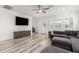 Living room featuring hardwood floors and a gray sofa at 19305 S 209Th Pl, Queen Creek, AZ 85142